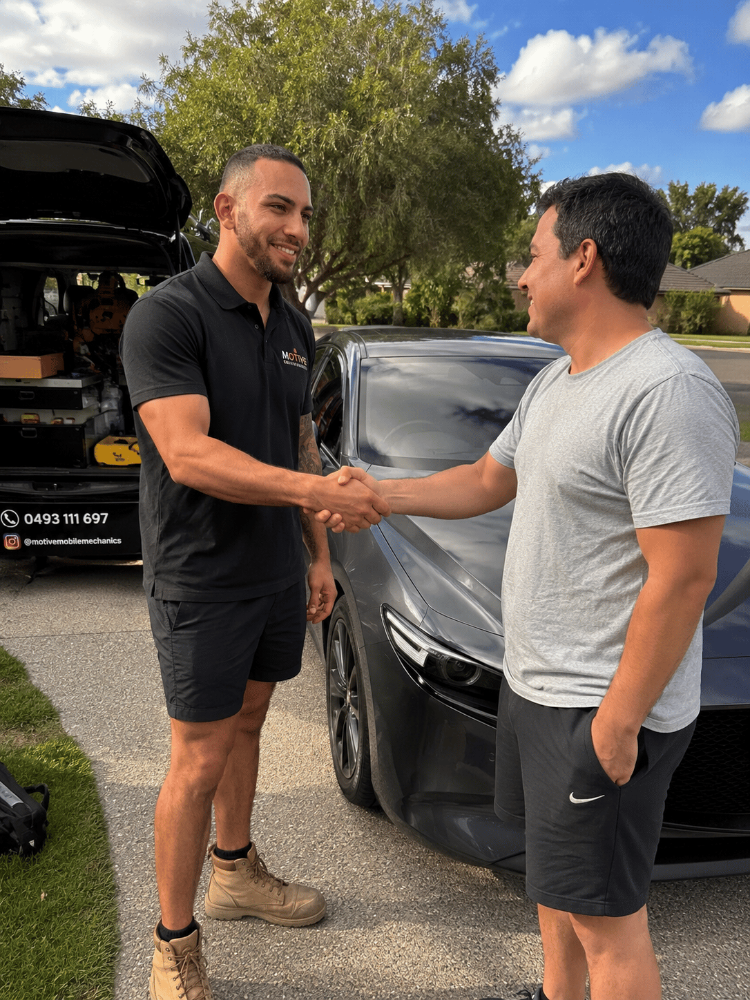 Happy Logan customer beside their serviced car